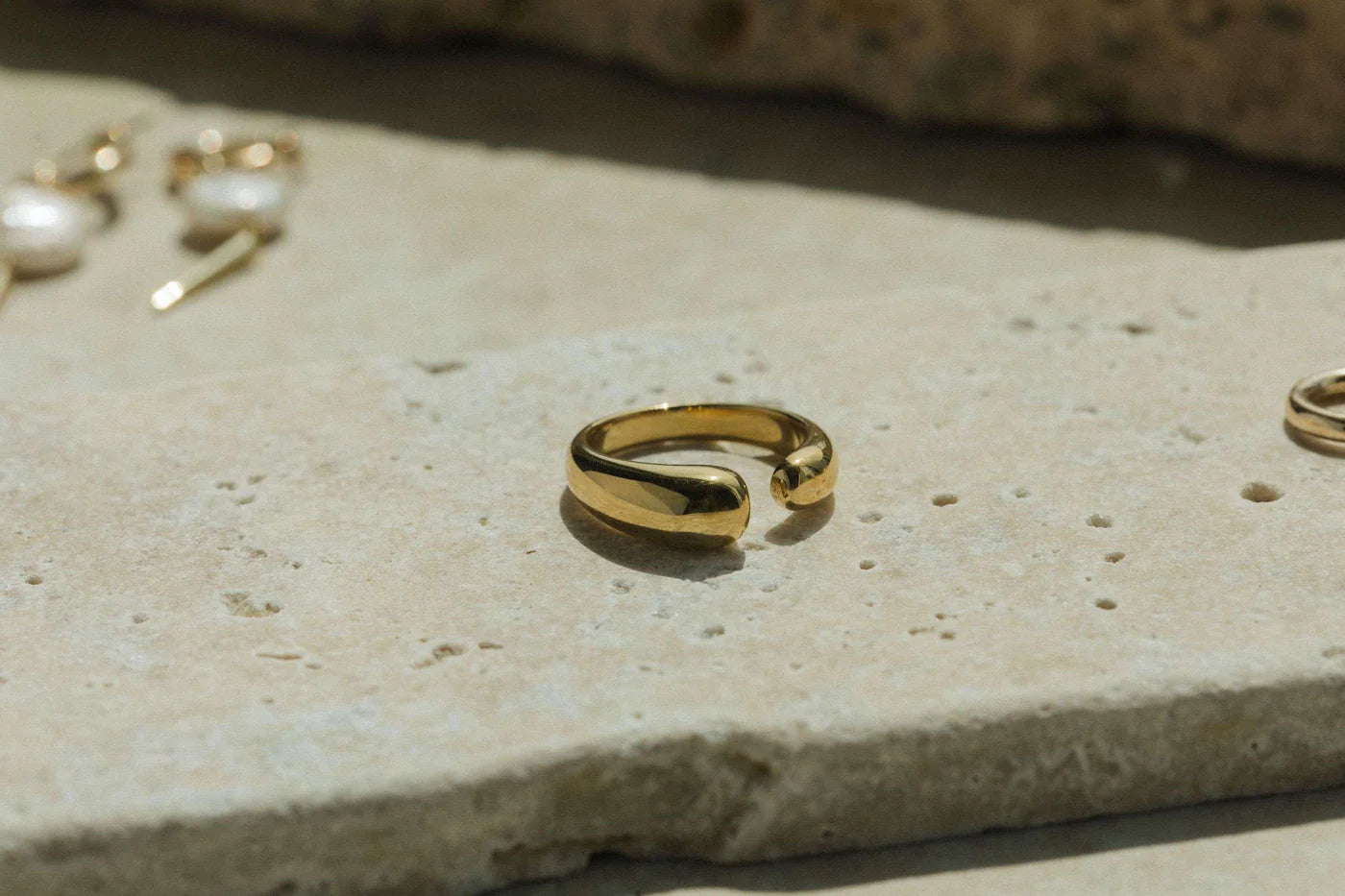 Gold ring on a textured stone surface