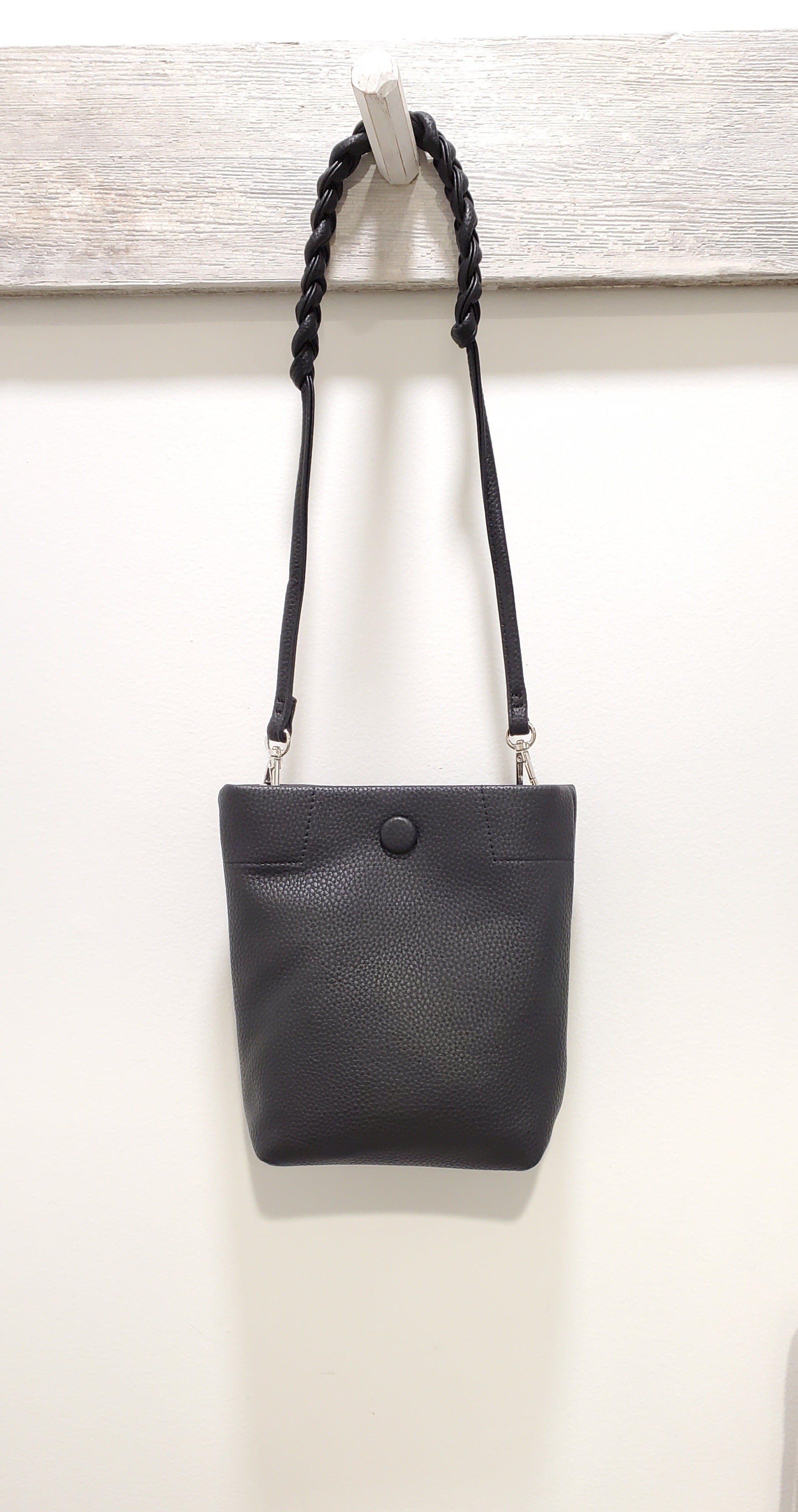 Black faux leather cellphone case with snap closure and adjustable handle.