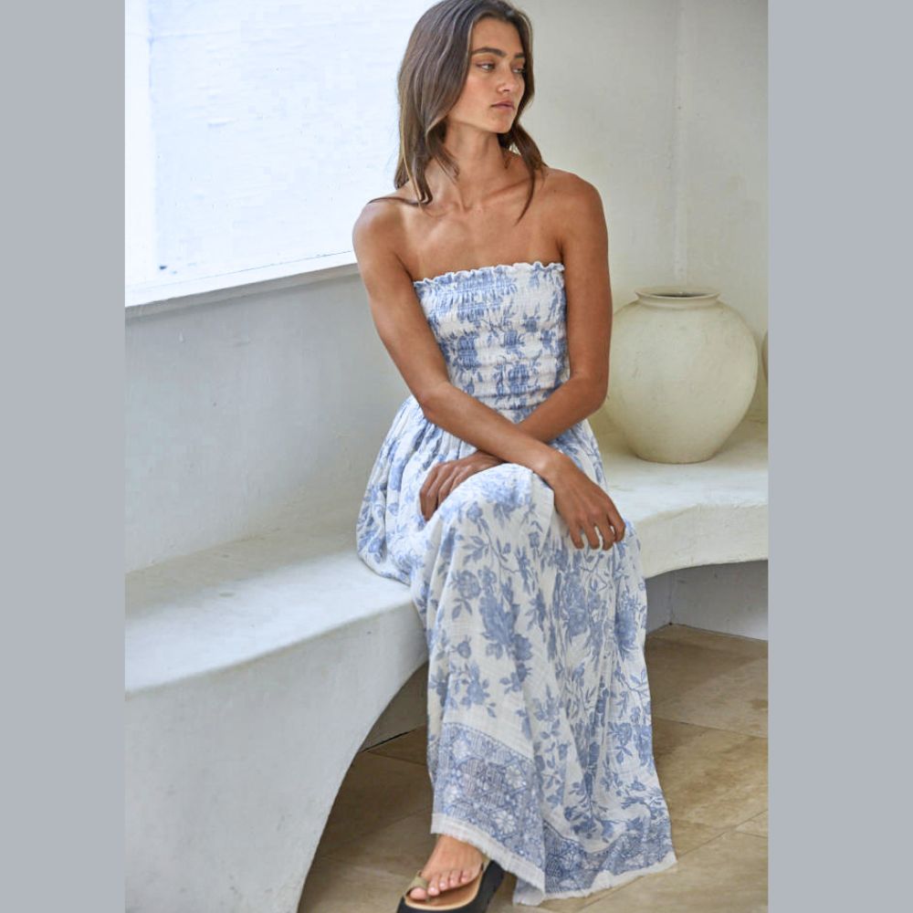 model wearing a light blue and ivory print tube top maxi dress