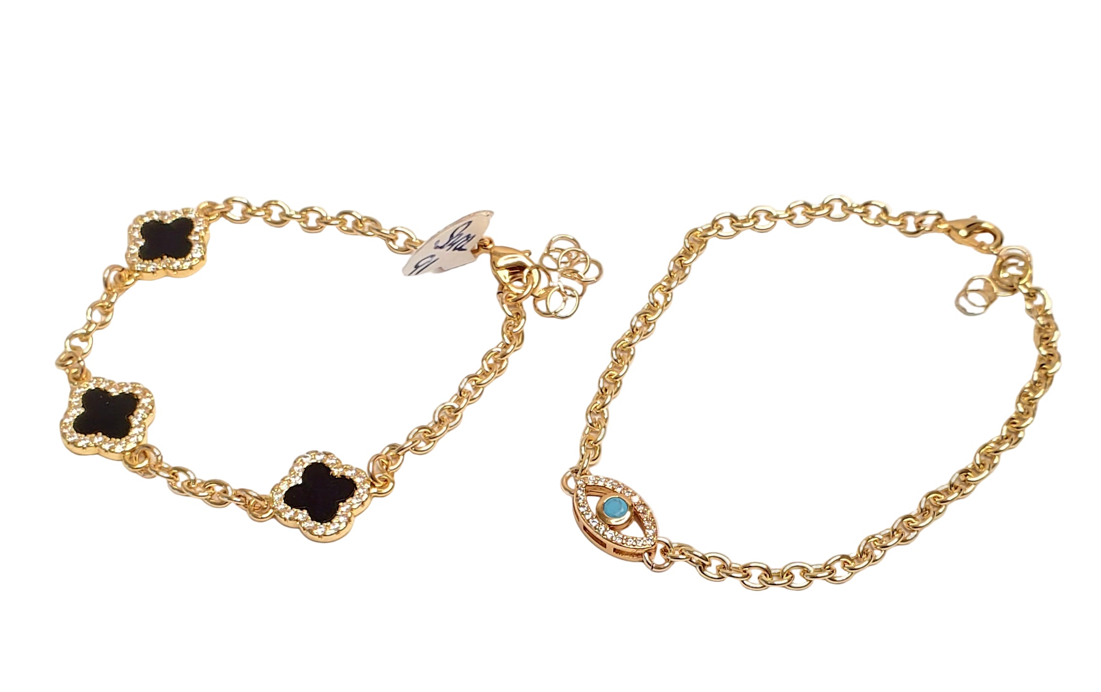 Two gold bracelets with black and blue stone accents on a white background