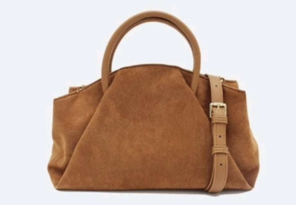 A faux suede crossbody fold over handbag with detachable strap and hand held straps.